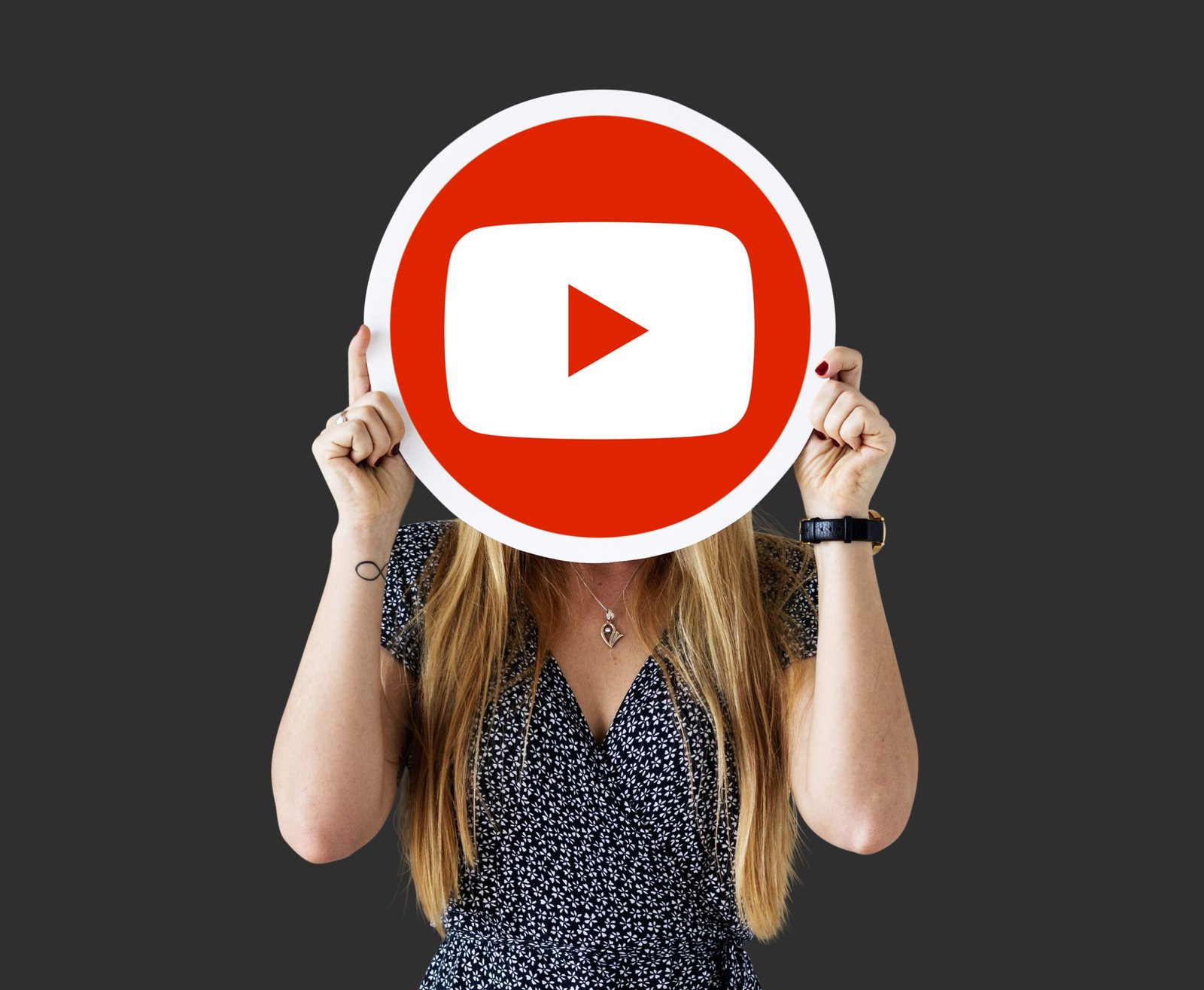 woman holding youtube icon scaled